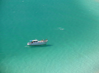 Boat over a crystalline turquoise beach in Arraial do Cabo
