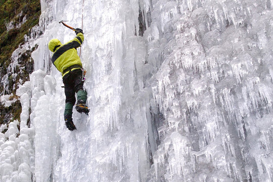 Ice Climber On Frozen Waterfall