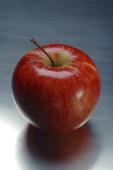 still life: red apple on the metal table