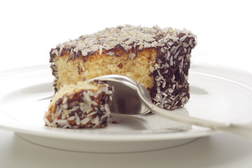close-up pieces of cake and silver spoon on a plate