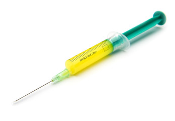 Fototapeta premium syringe filed with yellow liquid isolated on white background