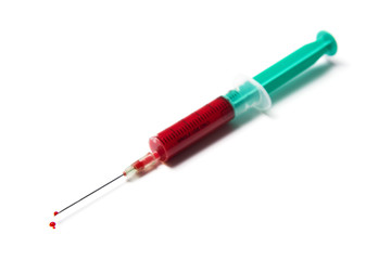 Fototapeta premium syringe filled with blood, drops at tip of needle, isolated