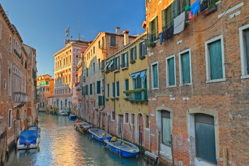 Fototapeta na wymiar Typical canal in Venice, Italy with boats and nice weather