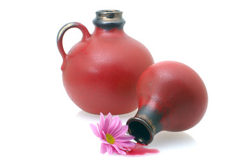 two wine jugs with a flower and wine