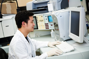 A shot of a laboratory technician working on a computer