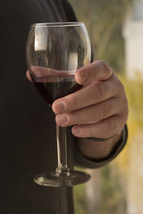man holding a glass of red wine