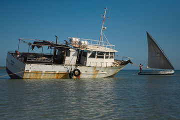 rusted fishing boat and a dhow on the islands