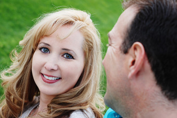 Fototapeta premium a happy couple smiling in green park environment