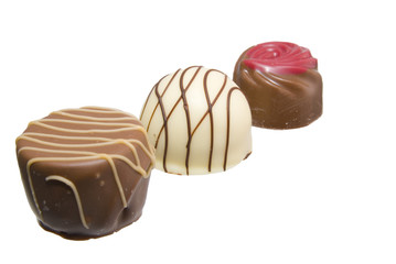 Three chocolates, milk and dark on a white background