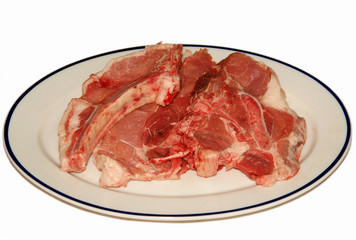 fresh red meat chops in white porcelain dish