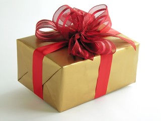 Christmas gift with red ribbon and golden paper