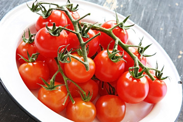 Cherry truss tomatoes,in an enamelled bowl 