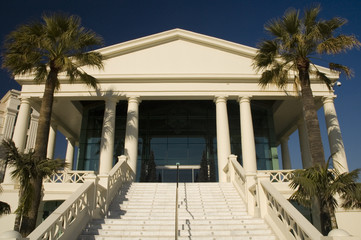 Mediterranean neo-classic building with palms on the sides