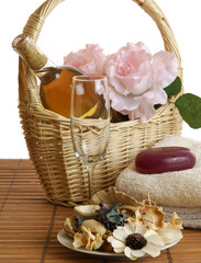 A basket of wine and roses with spa soaps