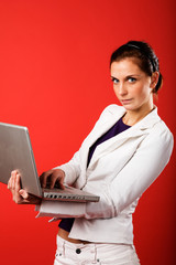 A young business woman or student using a laptop 