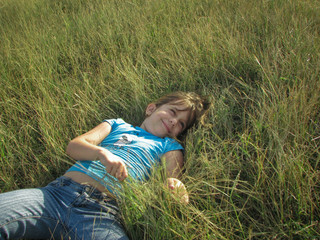 Beautiful little girl playing in the grass