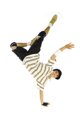 Young smiling bboy standing on one hand. 