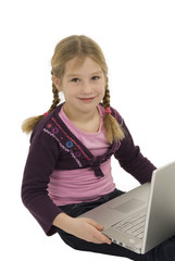 a little cute girl with a laptop against white background