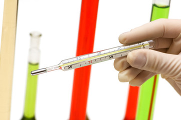Hand holding thermometer and tubes at the background