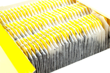 Black tea bags in pack isolated on white