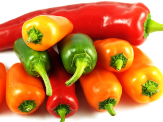 Mixed sweet and chilli peppers over white background