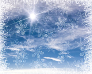 Cold background frame with blue sky and snow flakes.