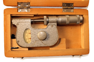 old micrometer in wooden box isolated