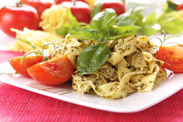 Spaghetti with pesto sauce and cheese