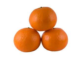 Three ripe oranges on a white background