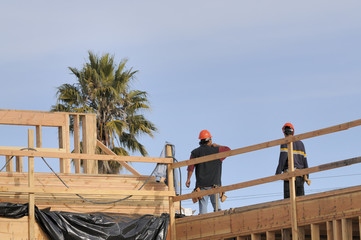 hispanic carpenters working on an apartment building 