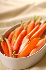 Fresh organic honey glazed baby carrots in a serving bowl