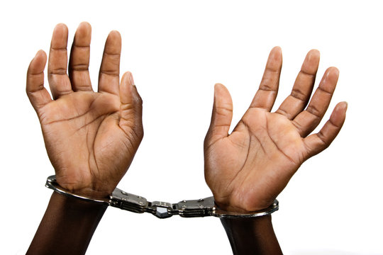 African American woman hands with handcuffs top view