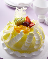 yellow color cake with fruits decoration