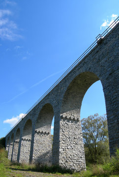 Old stone railway bridge with many bows