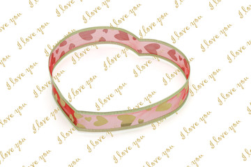 Heart shaped ribbon on  "I love you"  background