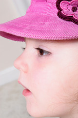 young girl in pink hat