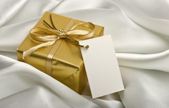 golden present with a note on silver silk close up