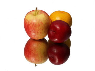 Apple orange and plum with reflection