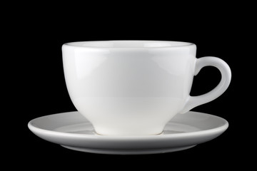 White cup and saucer isolated against black background