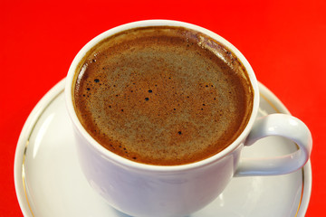 black coffee in the white cup. red  backgrounds