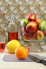 A table set with fresh apples and oranges