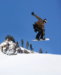 Snowboarder jumping high at Lake Tahoe resort