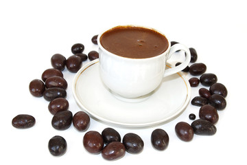 coffee in the white cup and peanut in chocolate
