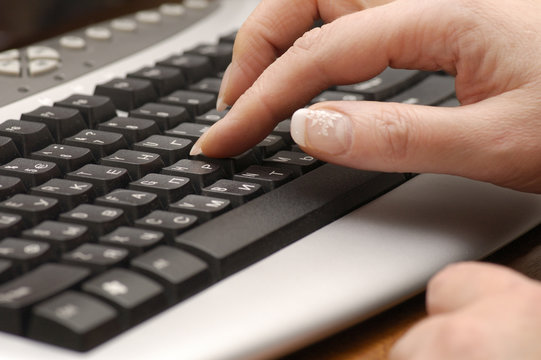 woman fingers on computer keyboard