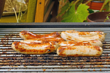 Roasted sausages on a grill.