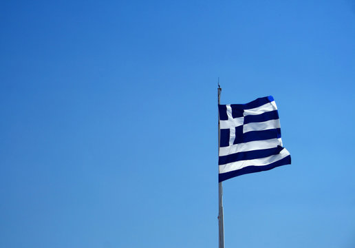 Greek national flag under blue sky