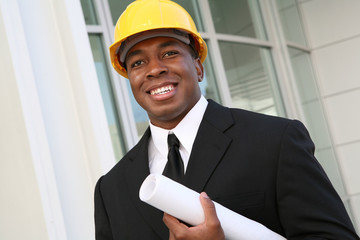 A young man working as an architect on a building site