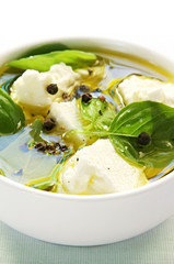 Goat's cheese (feta) flavored with basil leaves.