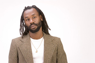 A black man with dreadlock hair isolated on a white background.