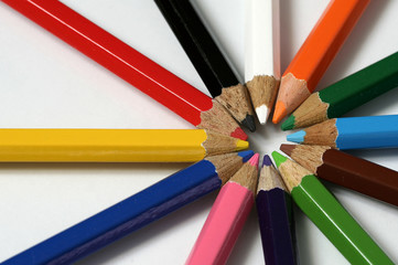 Circle of assorted colored pencil crayons